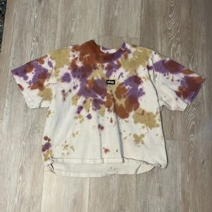 This shirt is yellow,red, and purple. This shirt is also a tiny bit cropped